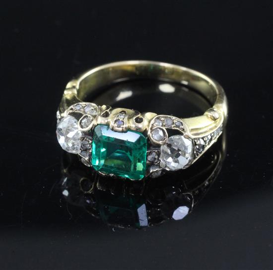 A 19th century gold, single stone emerald and two stone diamond ring, size M/N